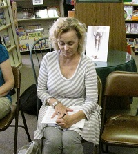 Karen Graham signing book for customer
